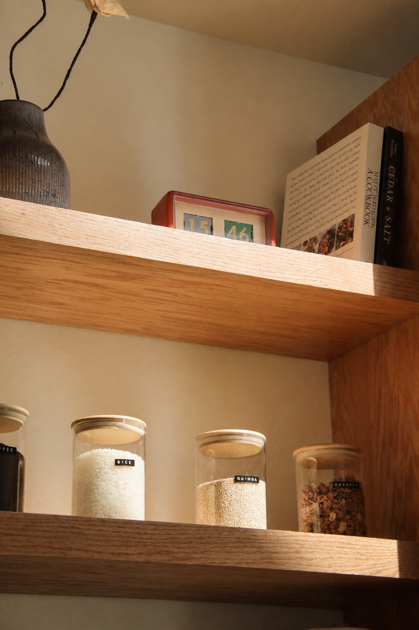 Sunlit kitchen shelves stocked with pantry staples at Norma cabin